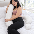 Mum-to-be hugging the Bump Nest Plus long pillow
